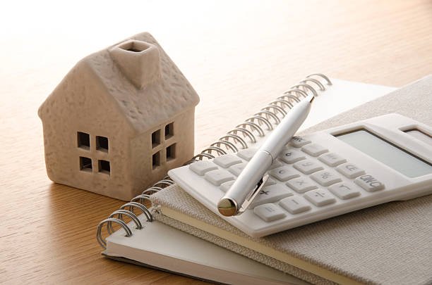 Toy house and calculator on the table